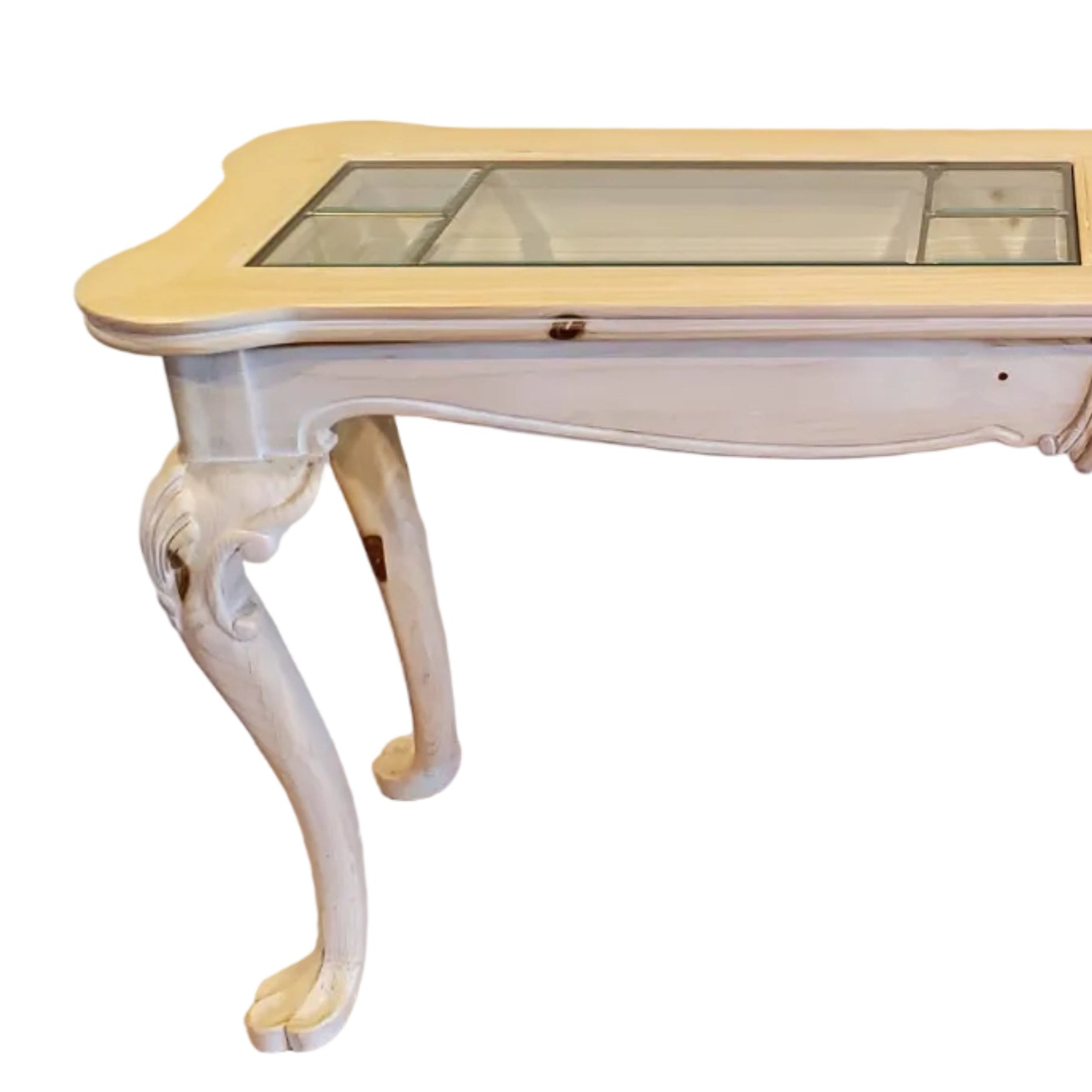 A vintage console table with a light wooden finish and glass panels on top, featuring decorative legs and a smooth surface, against a neutral wall.