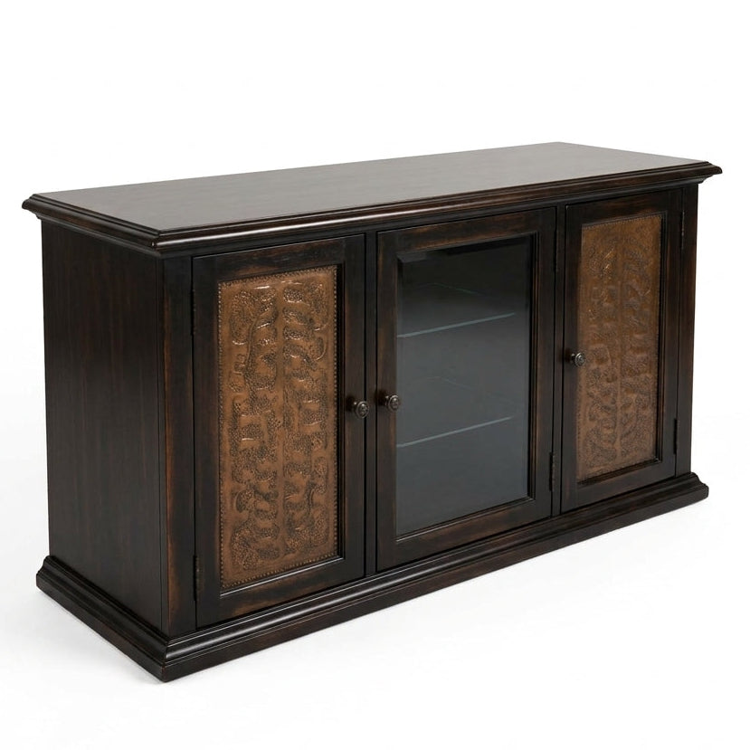 A dark brown wooden media console with carved bronze doors and a glass center door, shown on a white background.