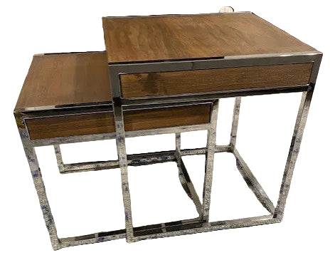 Two modern nested tables feature a sleek chrome frame and wooden tops, placed on a textured rug with blue and white patterns.