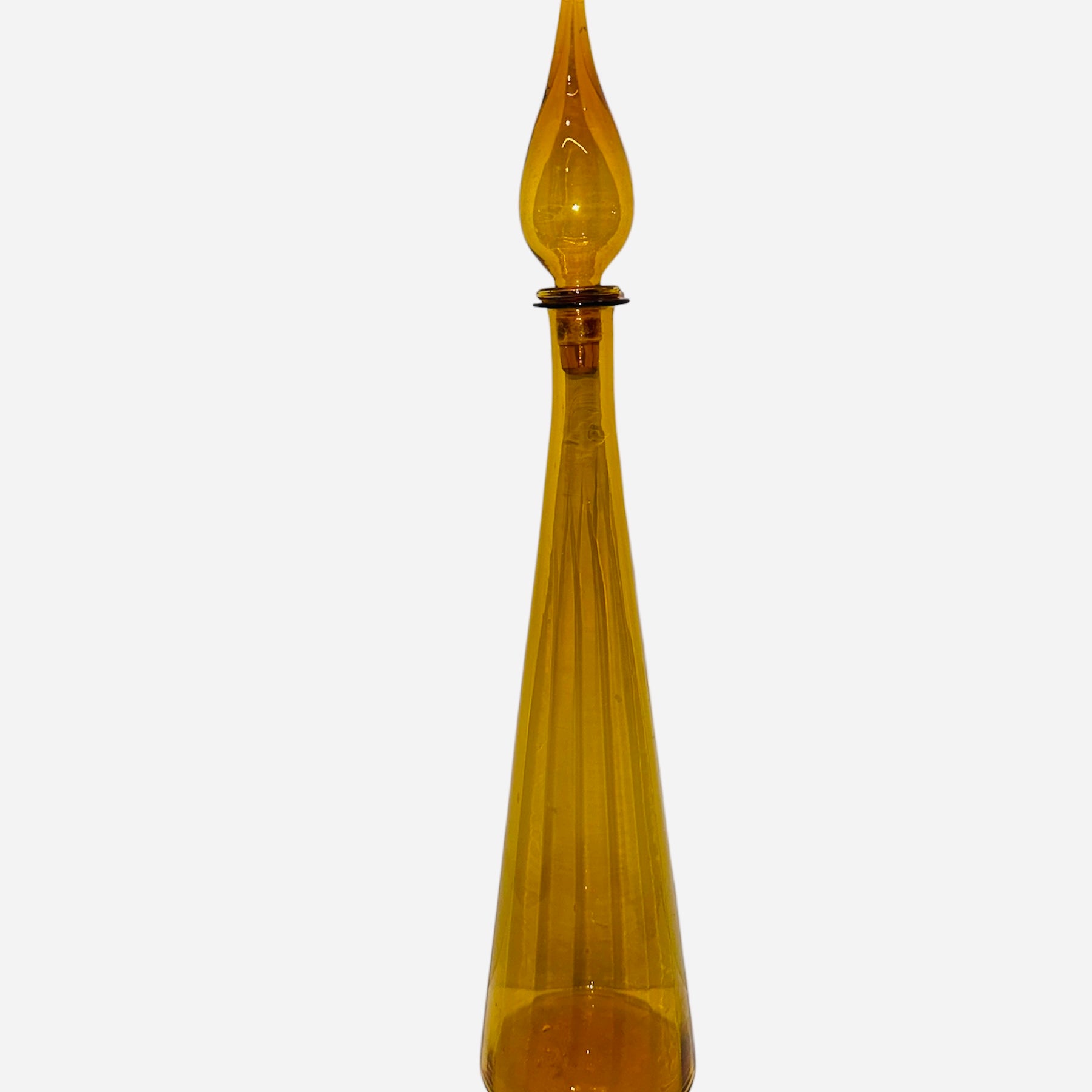 A tall, amber glass decanter with a pointed stopper, featuring vertical ridges along its body. The design is elegant and modern.