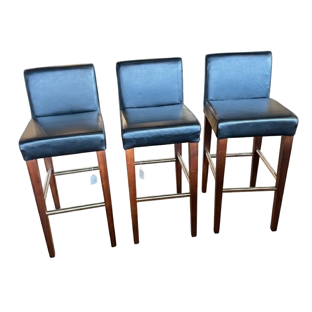 Three black bar stools with wooden legs on a white background