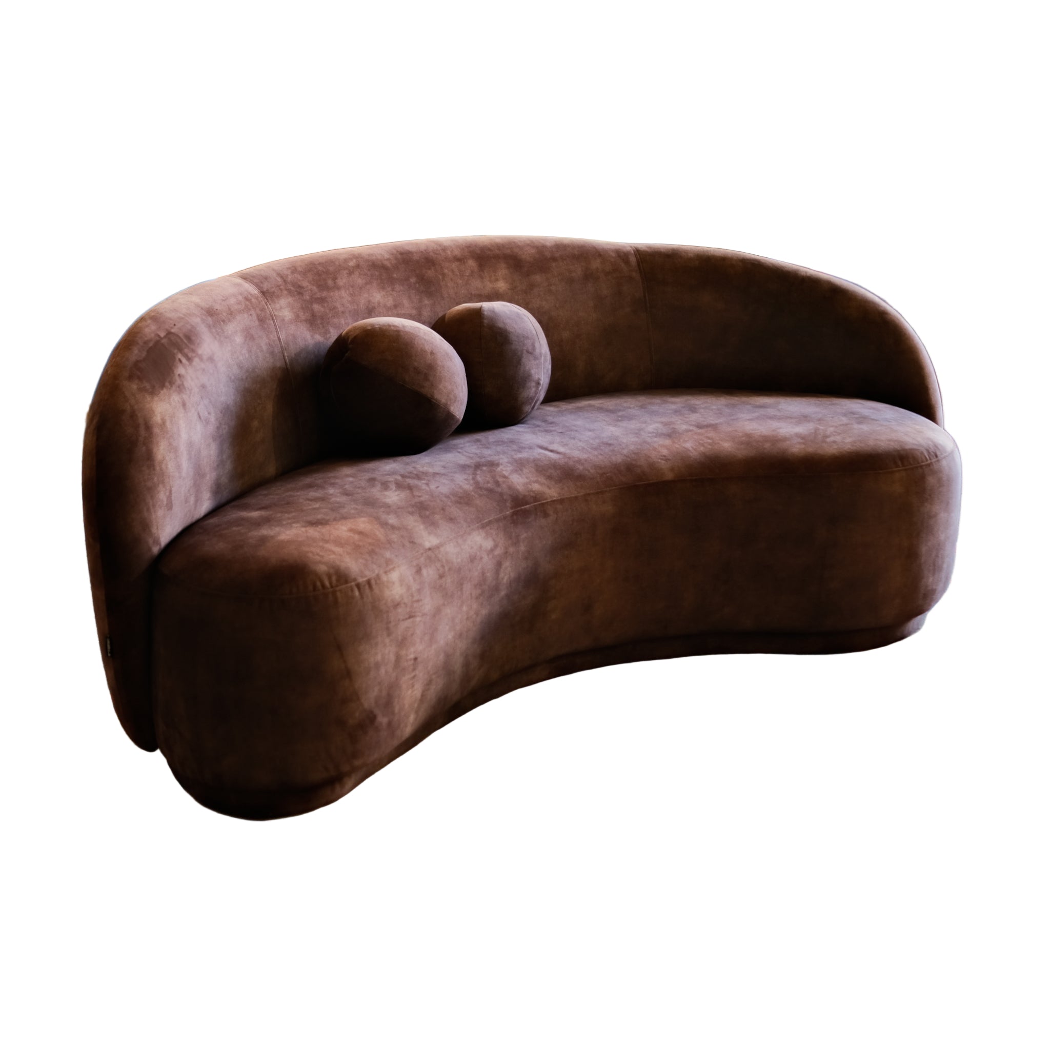 Brown curved sofa in a room