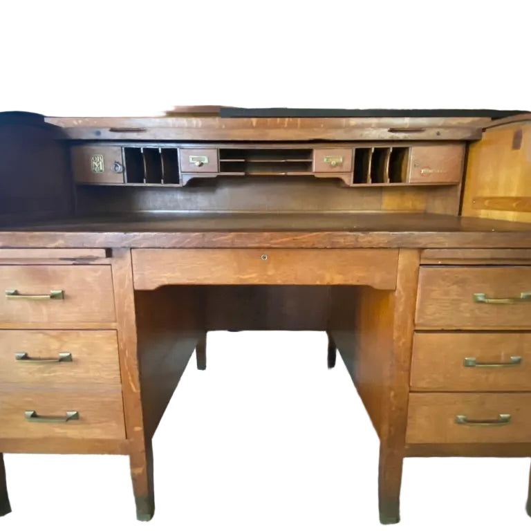 Wooden desk with a curved back, five drawers, and compartments for organization. Natural finish and vintage style, set in a cozy room.