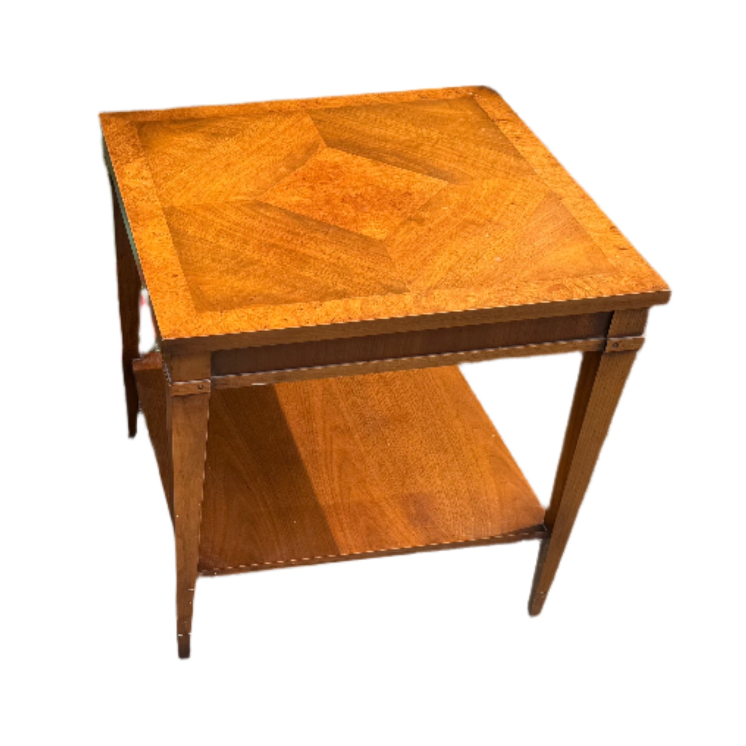 Two wooden side tables with geometric designs on the tops, set on a path beside greenery and gravel, showcasing their polished surfaces.