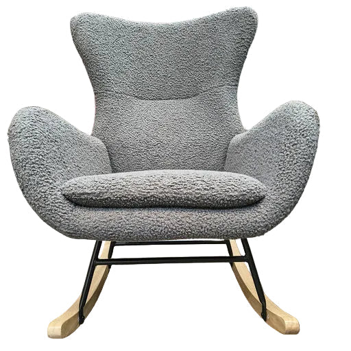 A modern gray rocking chair with a textured fabric cushion and wooden rockers, set against a workshop background with scattered boxes and materials.