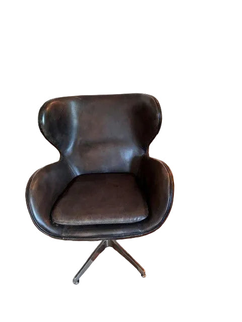 A stylish, modern black leather chair with a distinctive rounded backrest and a swivel base, set on a wooden floor with a light carpet.