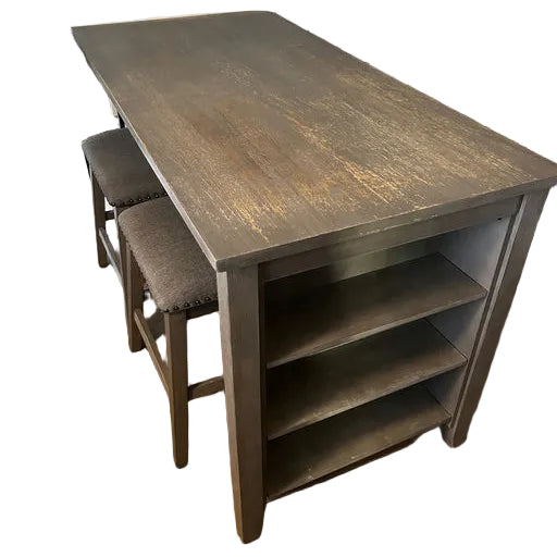 A rustic wooden table with two upholstered stools is positioned in a dining area, featuring open shelves underneath and a warm wooden floor.