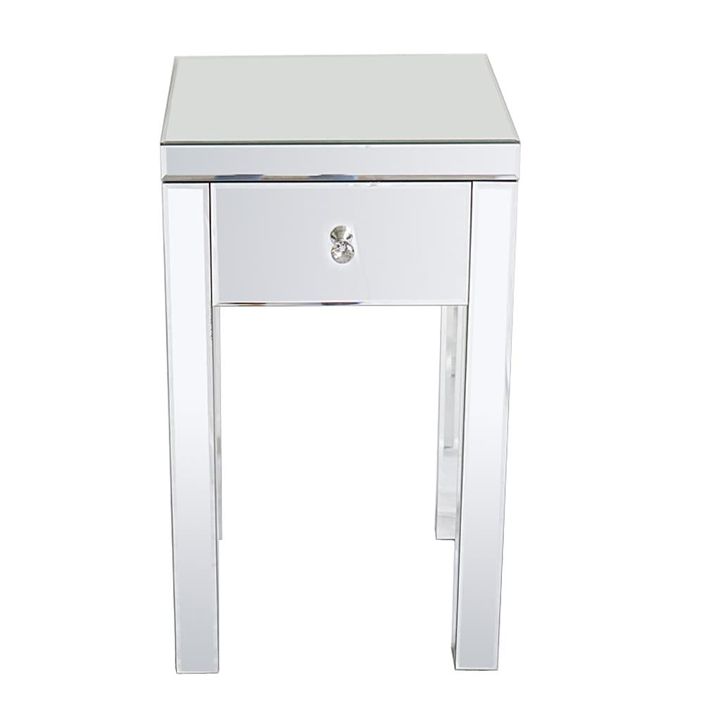 A mirrored side table with a single drawer and a crystal knob. The shiny surface reflects light, adding elegance to any room decor.