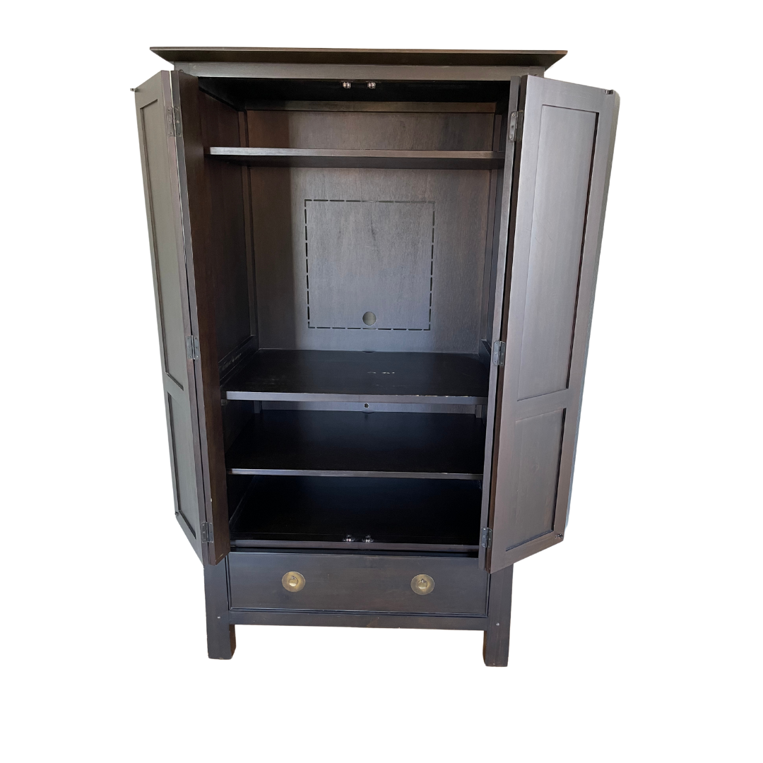Dark wooden armoire with two doors open, revealing three shelves and a lower drawer. It has a simple design, ideal for storage or display.