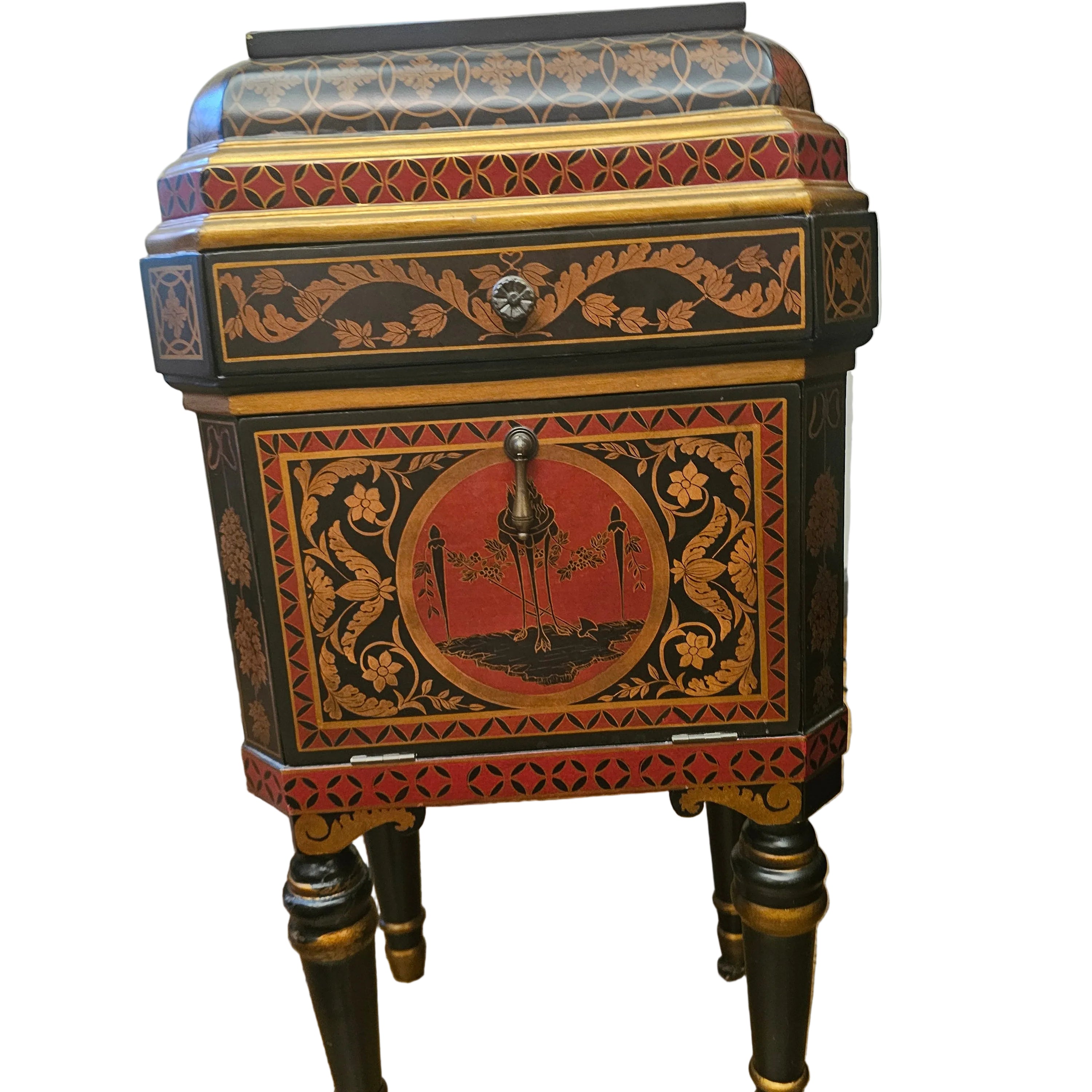 A vintage decorative nightstand with intricate floral patterns, featuring a red and black color scheme, and ornate gold detailing, stands on four legs.