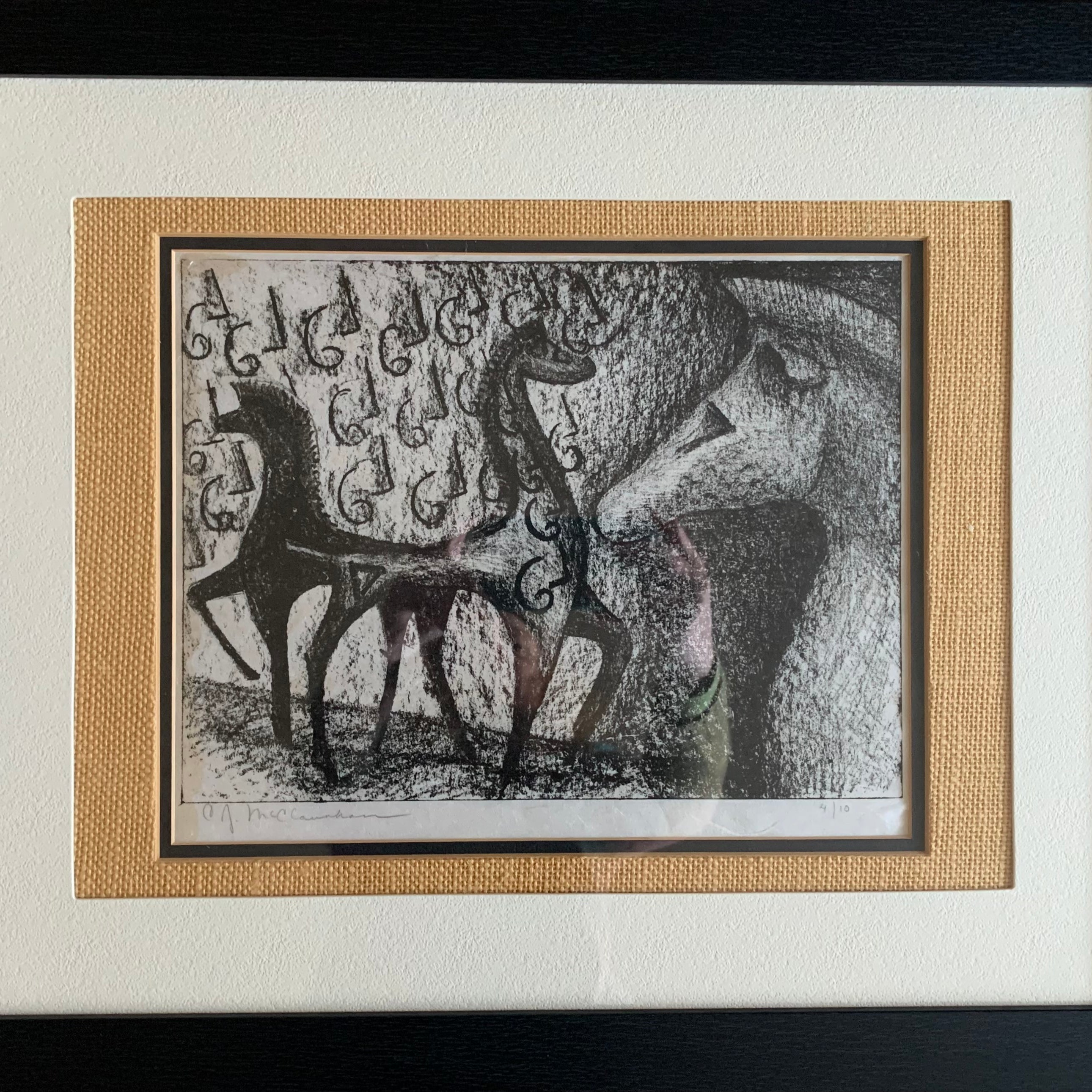 A framed artwork depicting stylized horses in black and white with intricate details, featuring a textured background and a signature at the bottom.