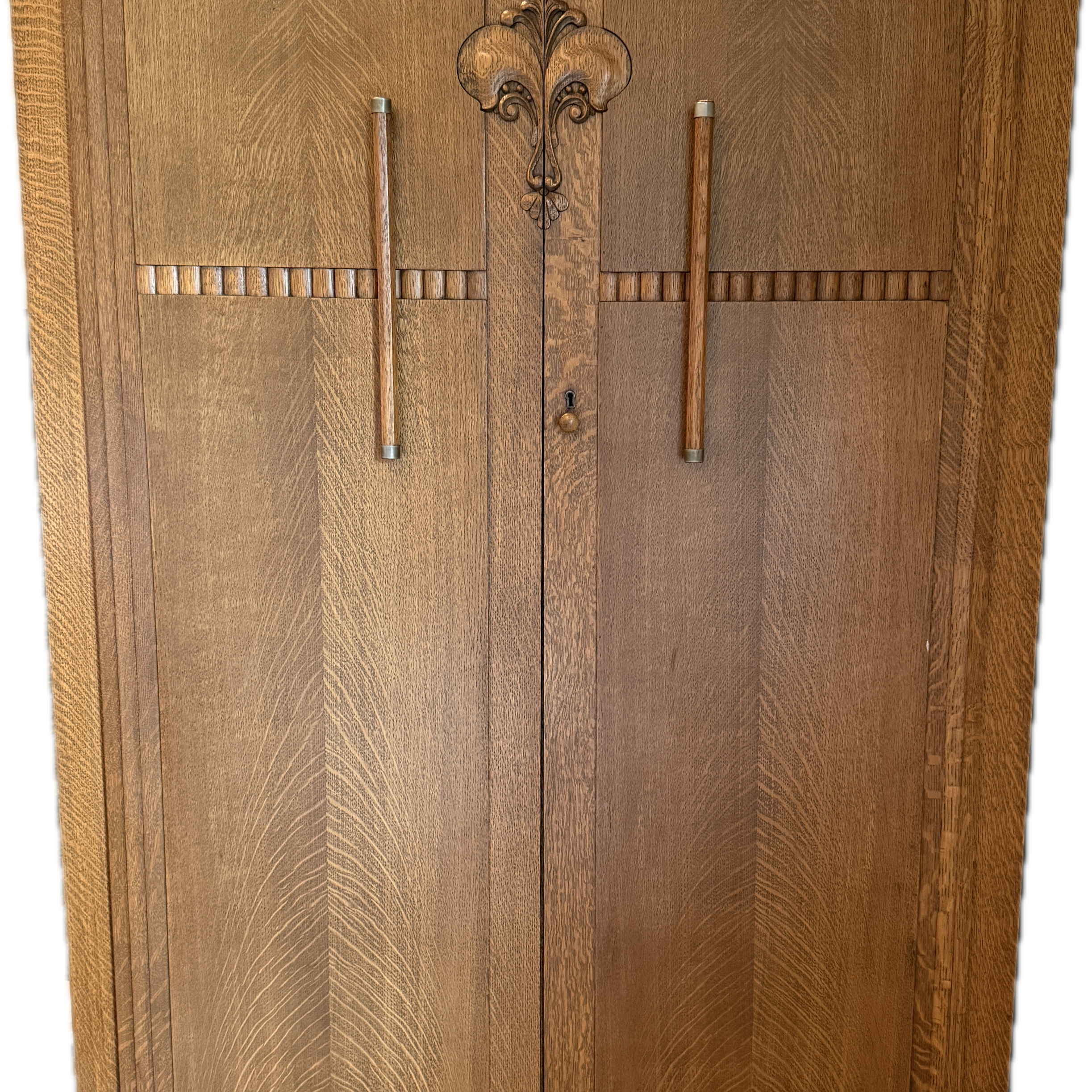 Art deco-style wooden cabinet with intricate grain patterns, featuring two doors, metal handles, and a decorative center motif.