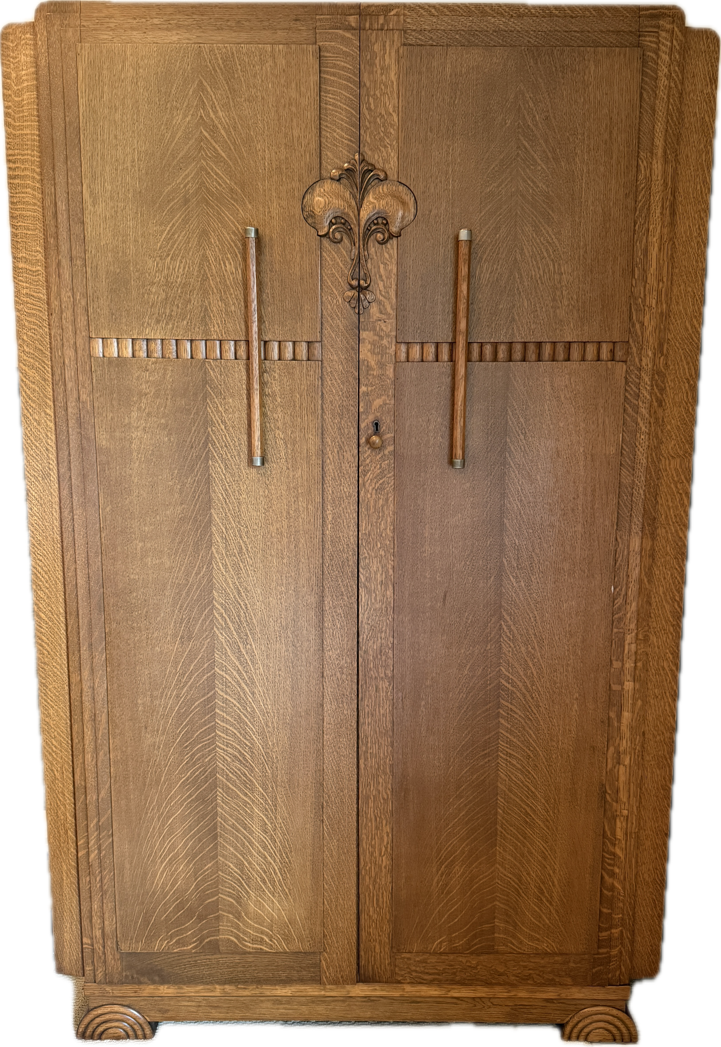 Art deco-style wooden cabinet with intricate grain patterns, featuring two doors, metal handles, and a decorative center motif.