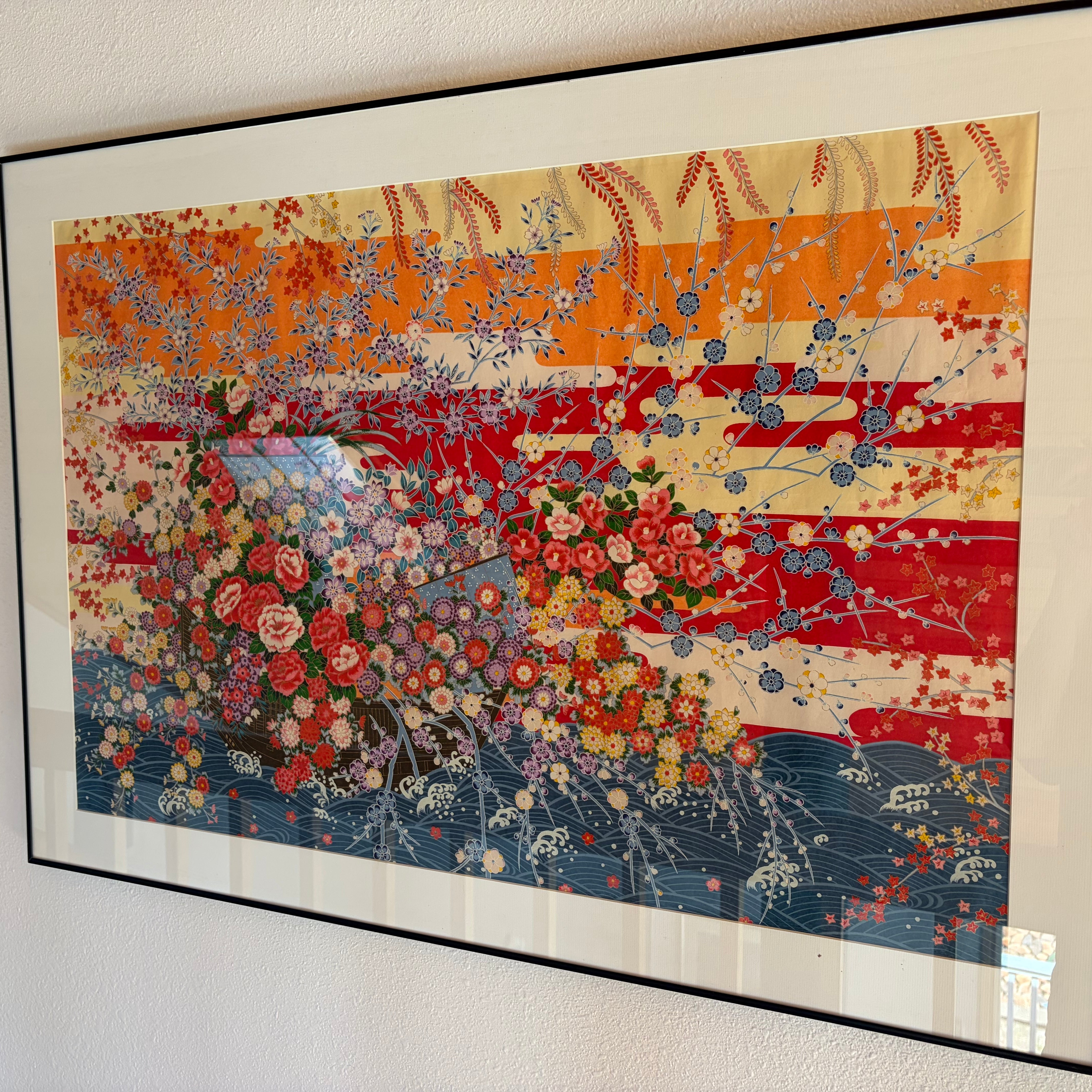 A vibrant framed artwork featuring colorful floral patterns and stylized waves, combining warm hues of orange and red with intricate details.