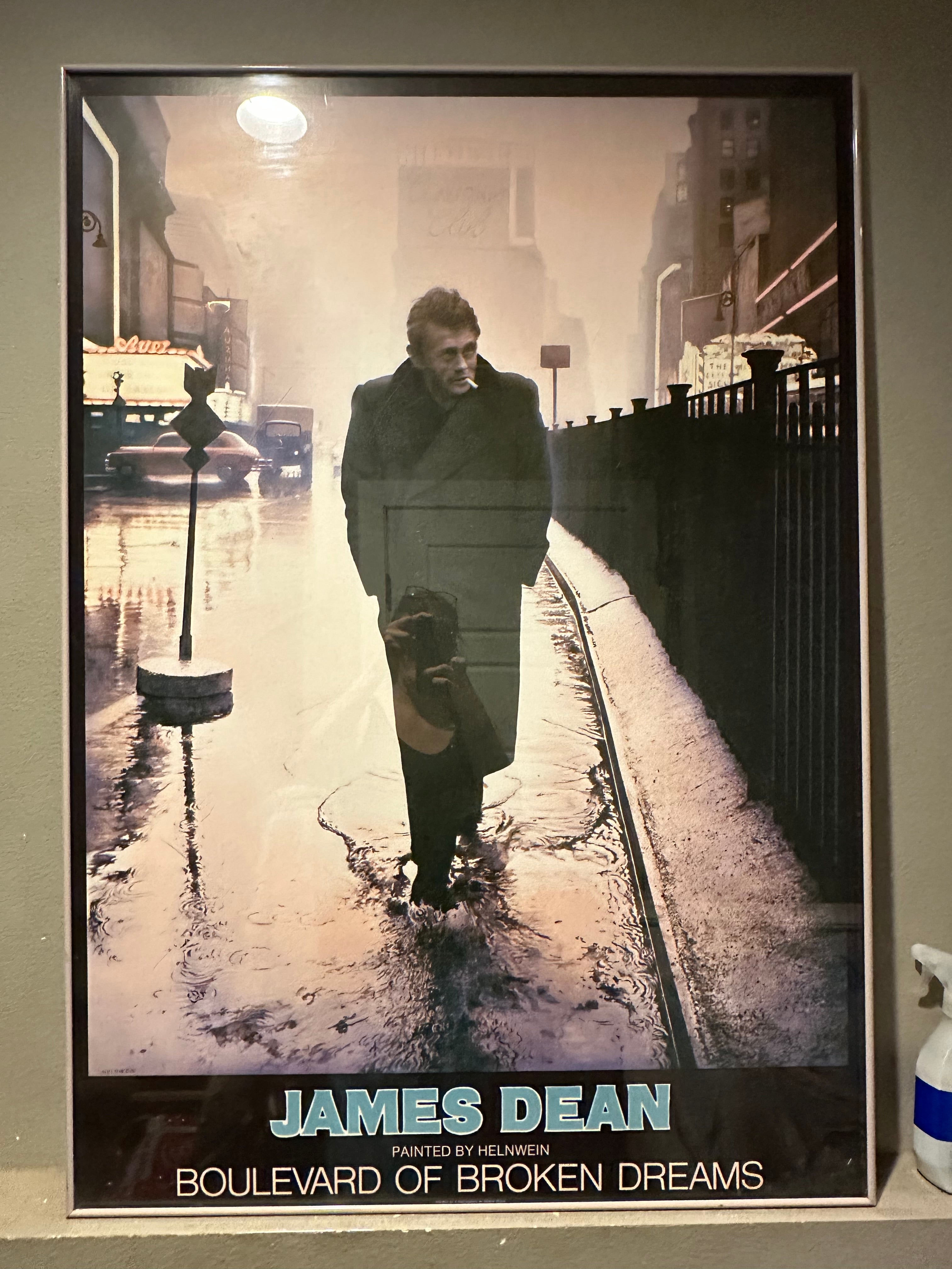 A framed painting of James Dean walking alone in the rain, titled "Boulevard of Broken Dreams," with a somber urban background.