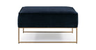 The Bumper is a modern elevated square ottoman in blue velvet fabric. It has a flat upholstered top cushion, gold metal frame with two rectangle side supports. Edge of ottoman has matching piping, sitting comfort is firm.