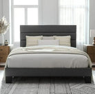 A modern bedroom featuring a gray upholstered bed with two decorative pillows. Light curtains frame the windows, and wooden nightstands add warmth.