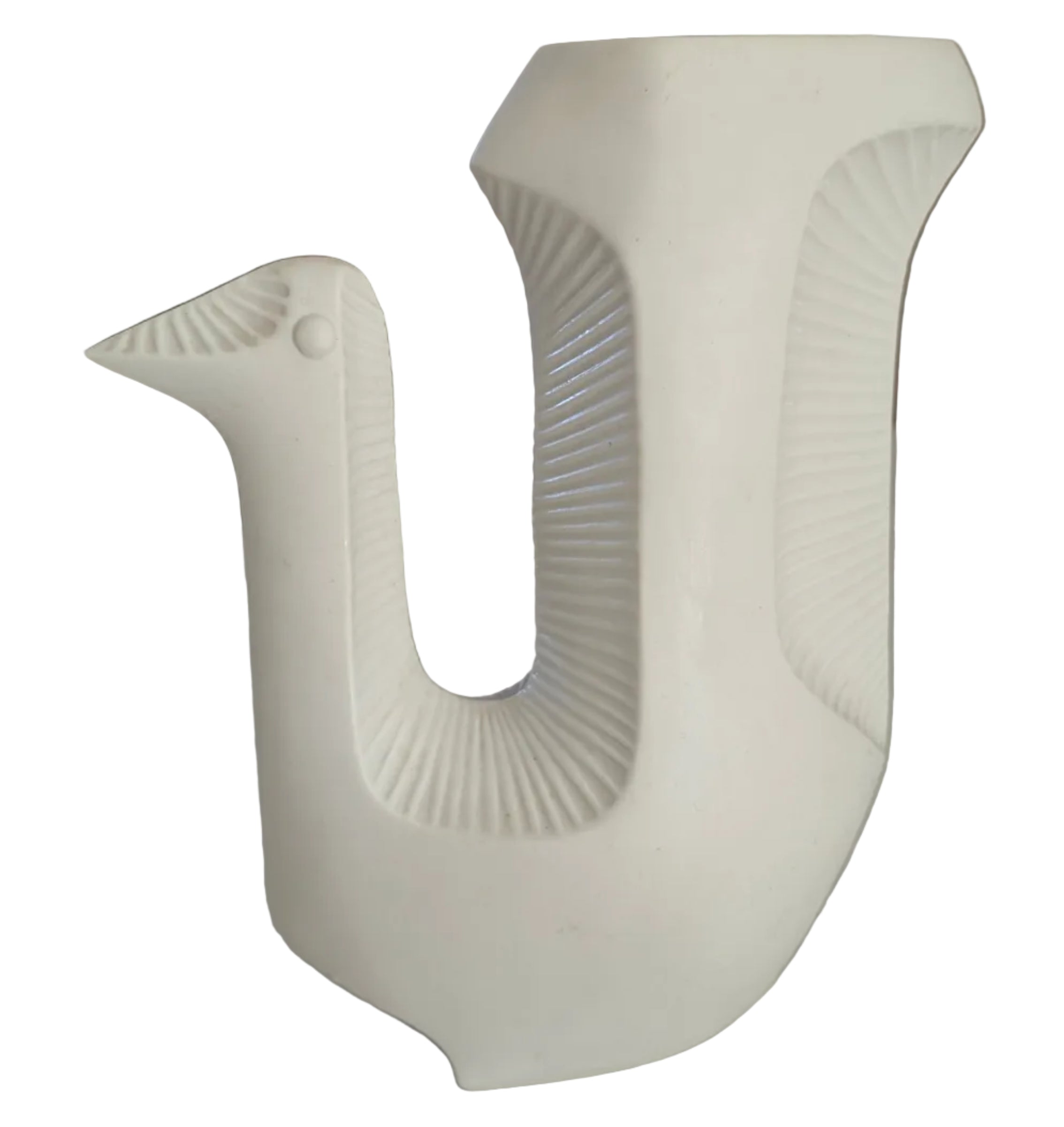 A white ceramic vase shaped like a bird, featuring a textured body and a distinctive beak, placed on a light-colored surface with a blurred background.