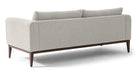 Colin is a modern sofa in textured white fabric. Fully upholstered with fixed seat cushions and removable back cushions. This sofa also features a unique way the arms are curved inward. Full width solid stained Oak frame and legs supports the sofa. The wooden legs are all turned outwards to the floor for a more stability. (Back)