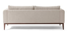 Colin is a modern sofa in textured white fabric. Fully upholstered with fixed seat cushions and removable back cushions. This sofa also features a unique way the arms are curved inward. Full width solid stained Oak frame and legs supports the sofa. The wooden legs are all turned outwards to the floor for a more stability. (Back)