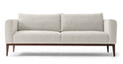 Colin is a modern sofa in textured white fabric. Fully upholstered with fixed seat cushions and removable back cushions. This sofa also features a unique way the arms are curved inward. Full width solid stained Oak frame and legs supports the sofa. The wooden legs are all turned outwards to the floor for a more stability. (Front)