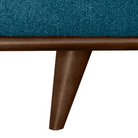 A detailed view of the blue sofa's wooden leg, emphasizing the sleek design and the material of the leg.