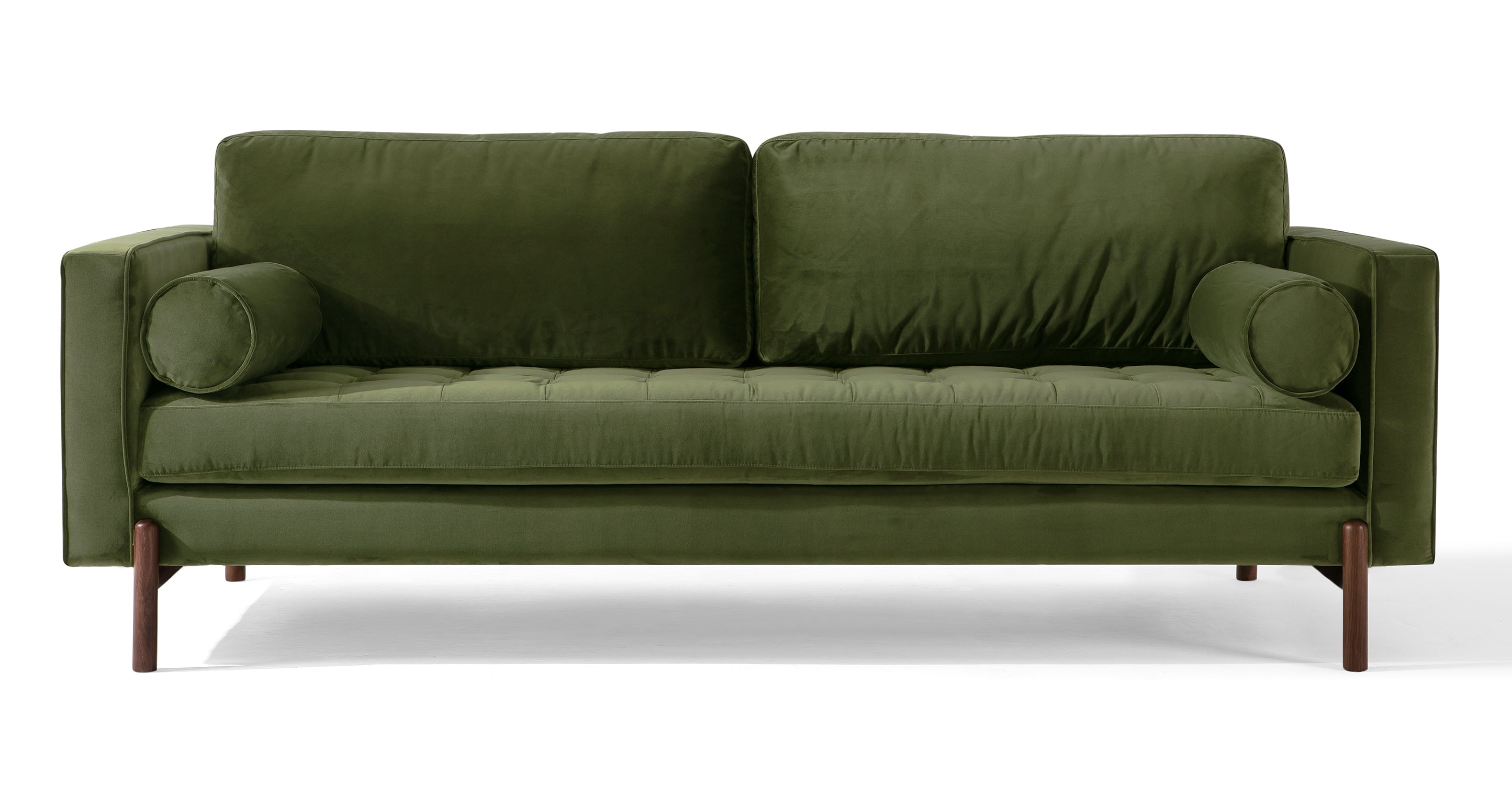 Dwell Fern modern sofa is 100% upholstered and features squared piping arms that meet two squared back cushions, creating a sleek and contemporary design. It comes with a single removable tufted seat cushion for added comfort, along with two bolsters on the sides to provide extra support. The two back cushions are also removable and extends beyond the chair frame, adding an interesting visual element. Four wooden leg supports add a touch of natural warmth and stability to the overall look.