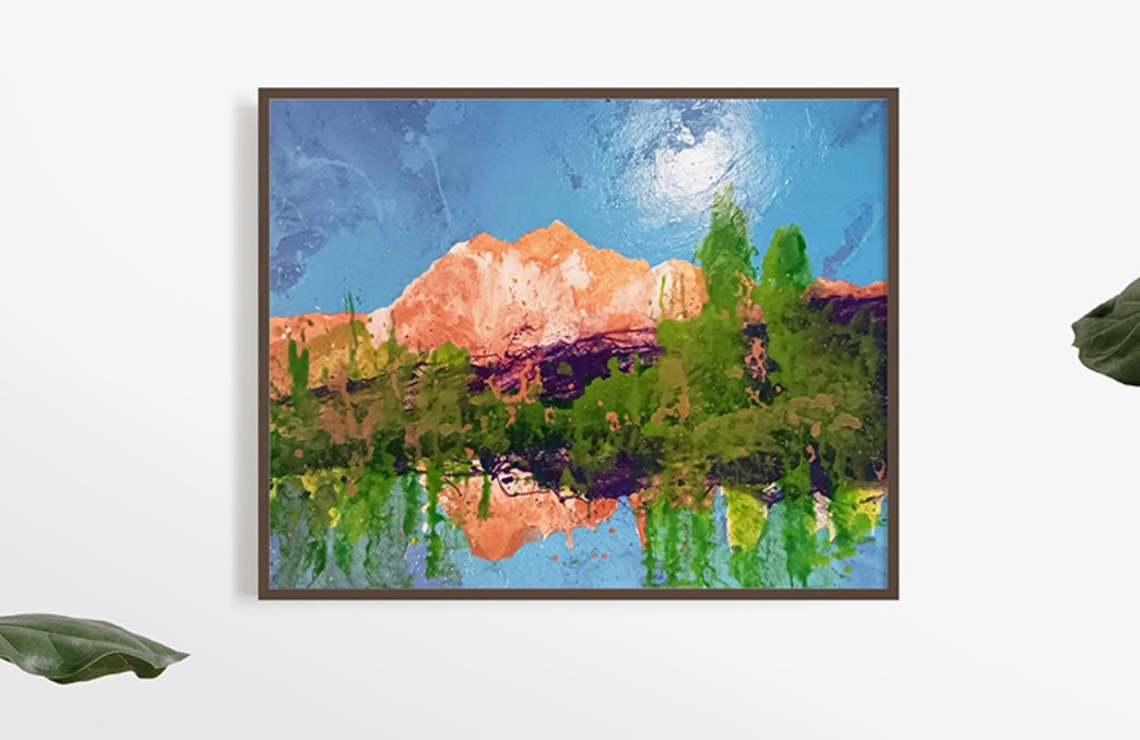 A colorful landscape painting featuring mountains, lush greenery, and a bright blue sky, with reflections in a serene water surface.