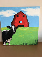 A black and white cow stands in foreground, with a vibrant red barn and blue sky in the background, depicting a pastoral scene.