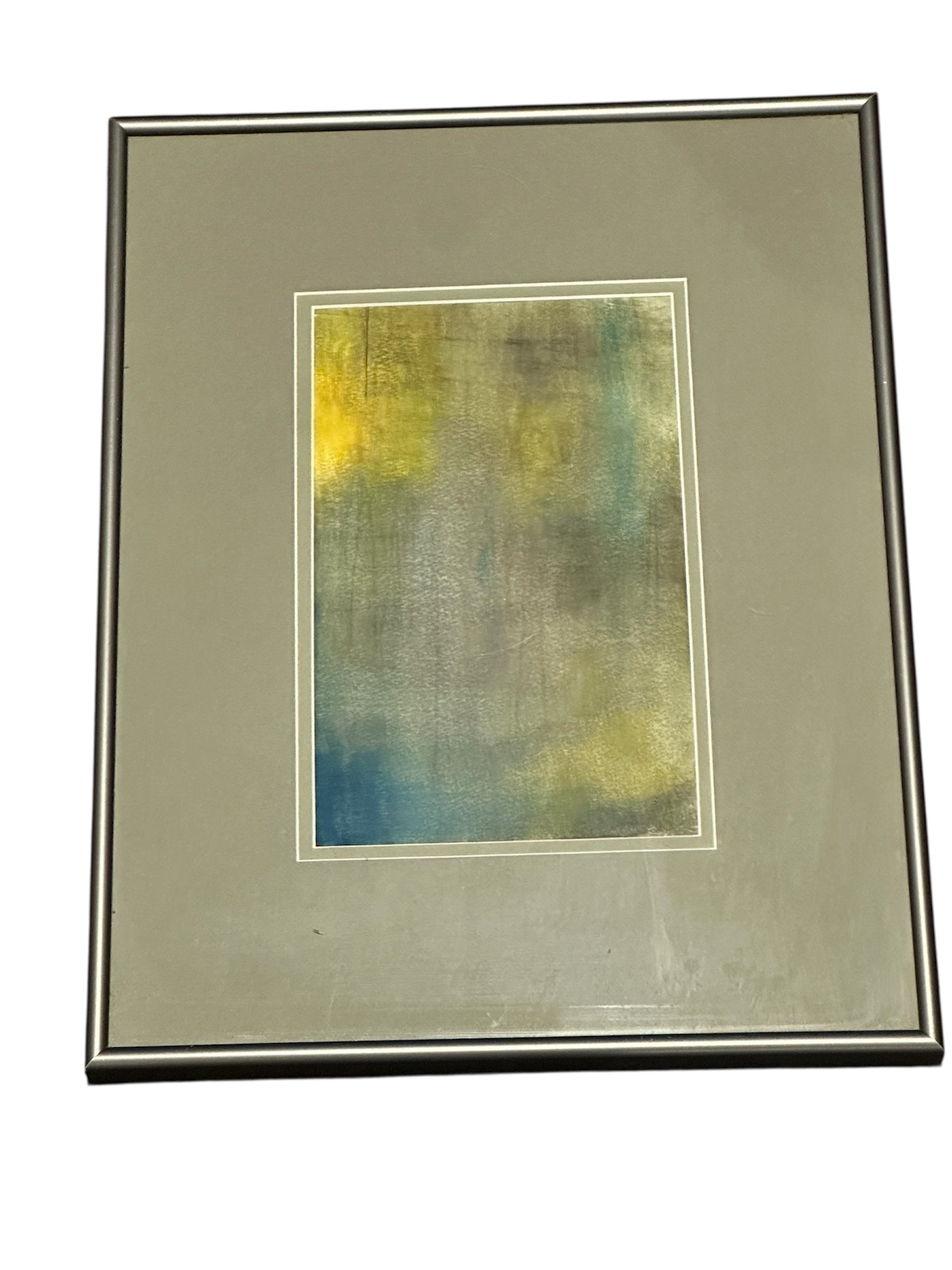 Framed abstract painting featuring a blend of muted colors like teal, yellow, and gray, set against a textured background.