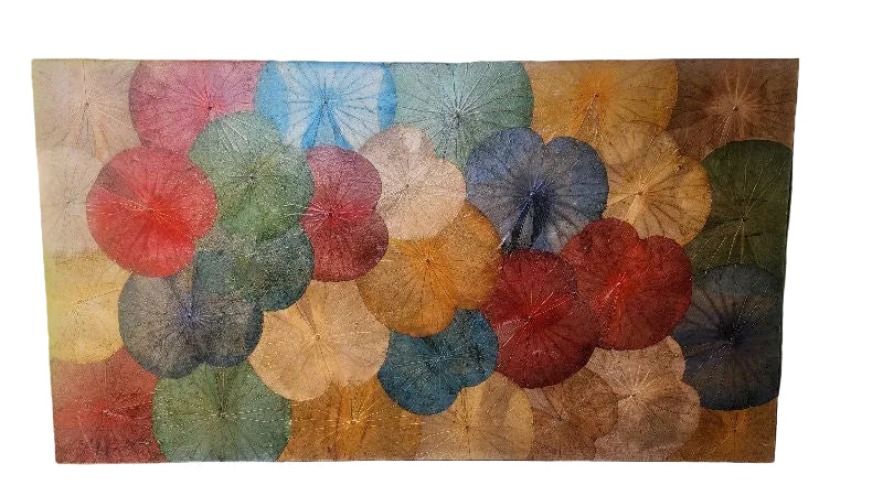 A colorful wall art piece featuring overlapping circular shapes in various hues, resembling flower petals, set against a neutral background.