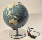 A blue globe features outlined continents and countries, resting on a chrome base. A USB cable is connected to the globe's side.