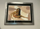 A framed illustration depicts a stylized figure lounging against a backdrop of soft, abstract shapes in warm tones. The figure has long hair and an expressive pose.
