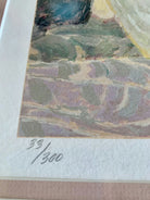 Close-up of an art print showing a signature and edition number "33/300" on textured paper, capturing details of the artwork's colors.