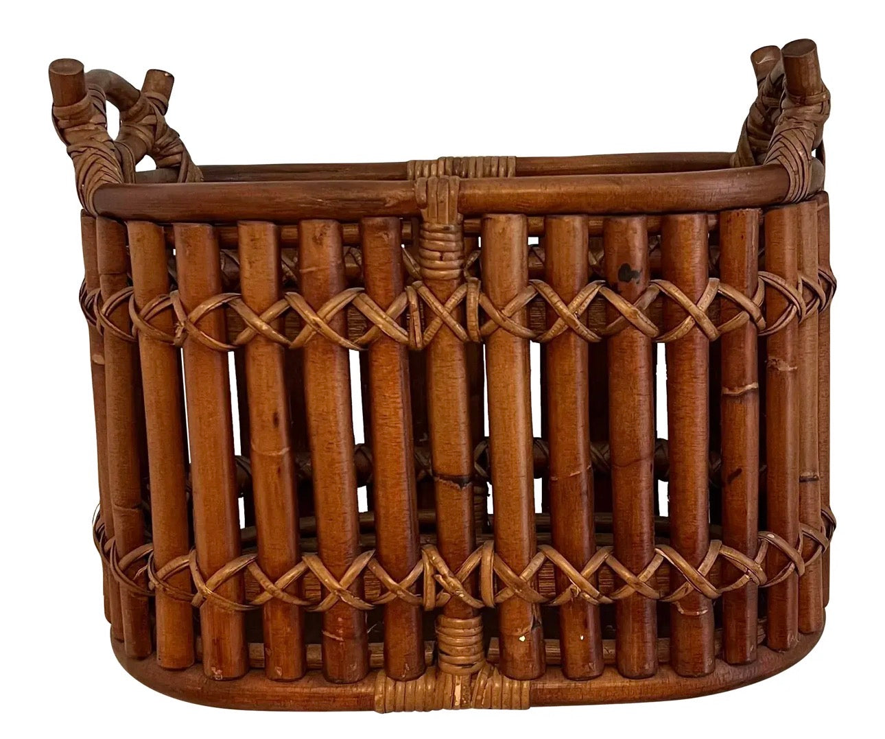 A woven bamboo basket featuring a rounded shape, intricate cross-pattern design, and sturdy handles for easy carrying and storage.