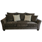 Brown sofa with decorative pillows on a white background