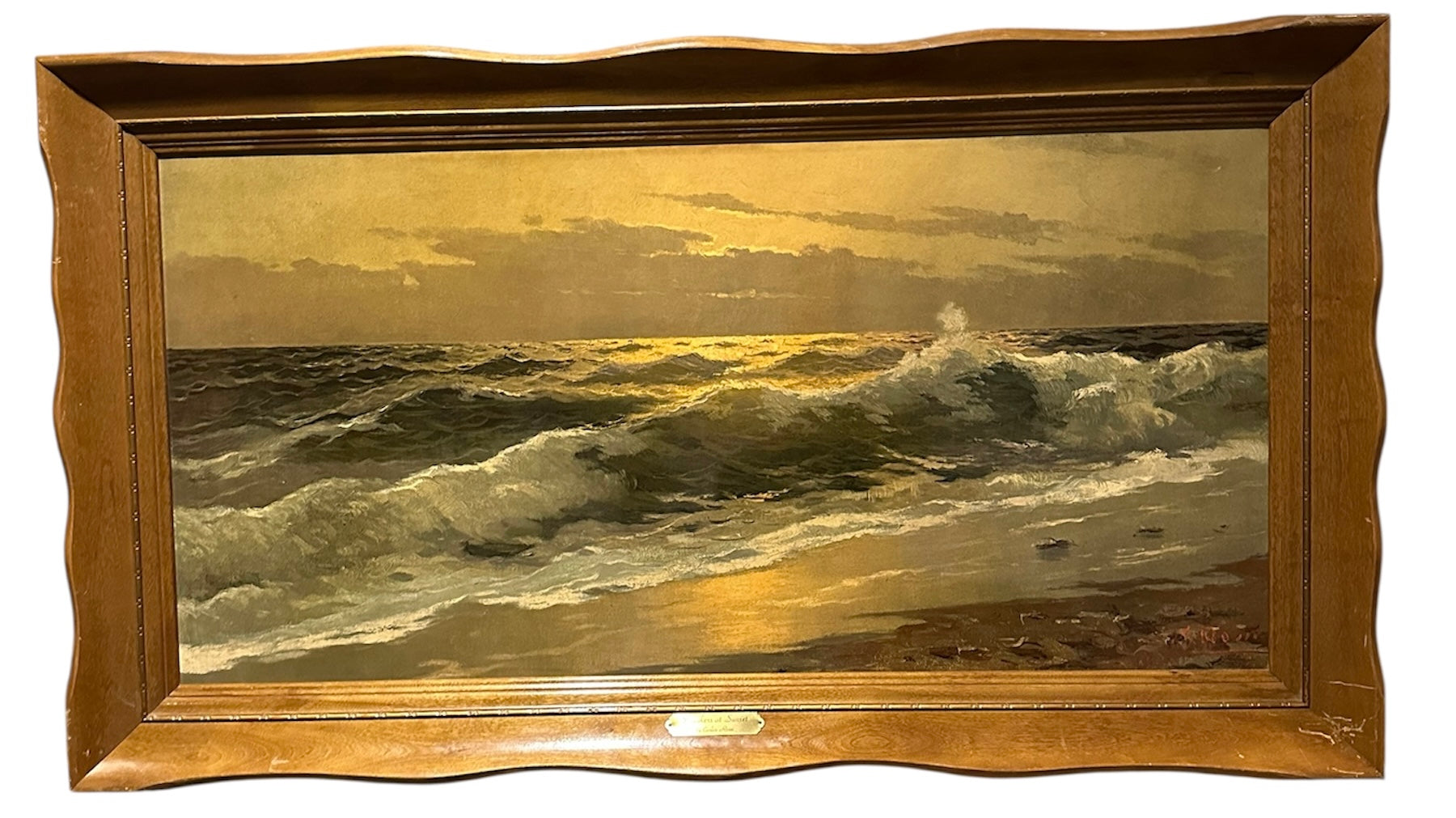 A seascape painting depicts waves crashing on a shore during sunset, with light reflecting off the water, framed in a wavy wooden frame.