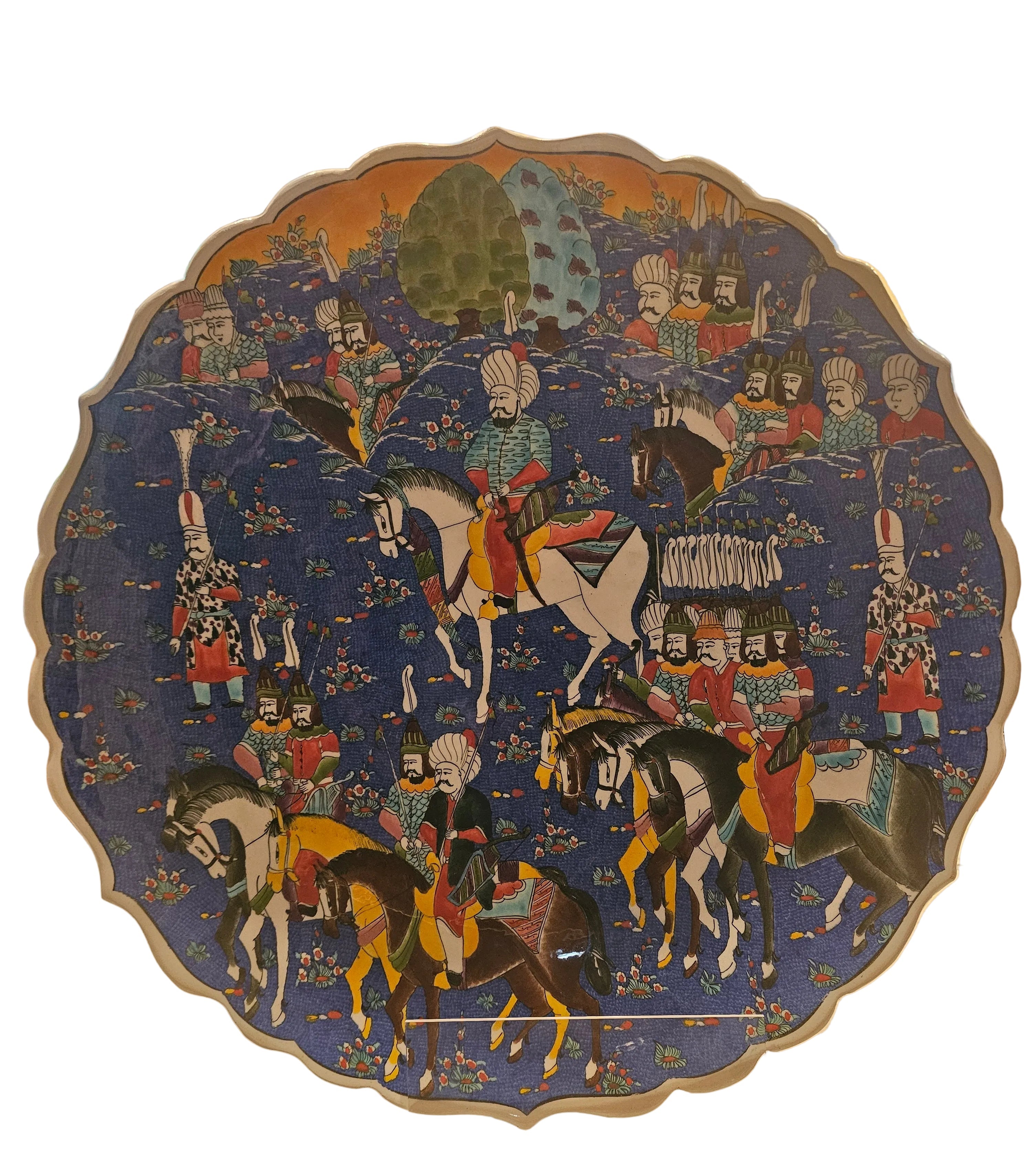 Colorful decorative plate featuring mounted figures in traditional attire against a blue background adorned with floral designs and trees.