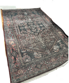 A richly patterned area rug with intricate designs in shades of red, blue, and gray, placed on a wooden floor in a bright room.