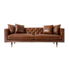 Brown leather sofa with tufted backrest on a white background
