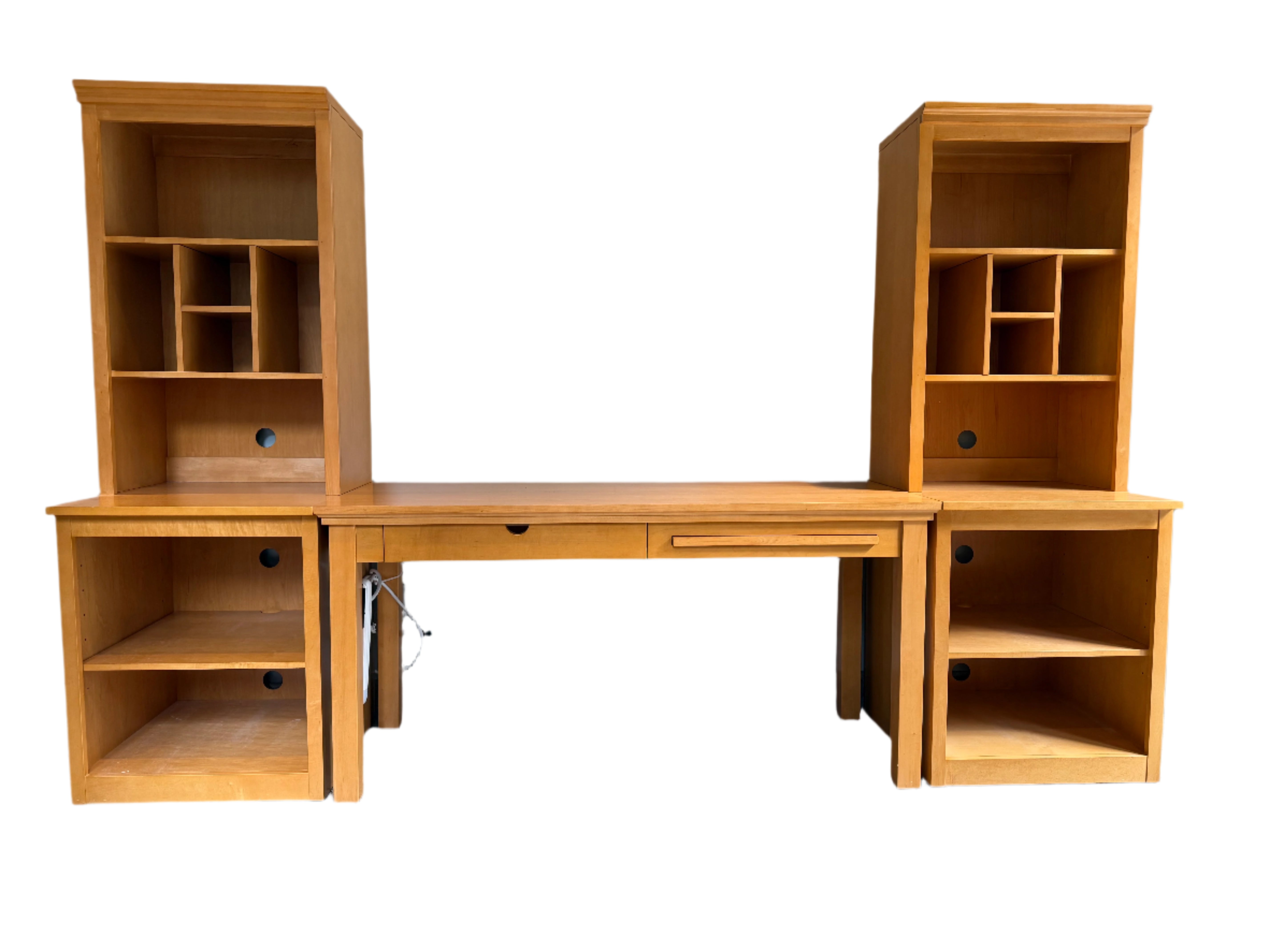 A wooden desk with two tall bookcases on each side. The desk features a pull-out drawer, and the bookcases have cubbies and open shelves.