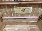 Inside view of a vintage cedar chest, featuring a text label detailing its features and guarantee, with a smooth, polished wood interior.